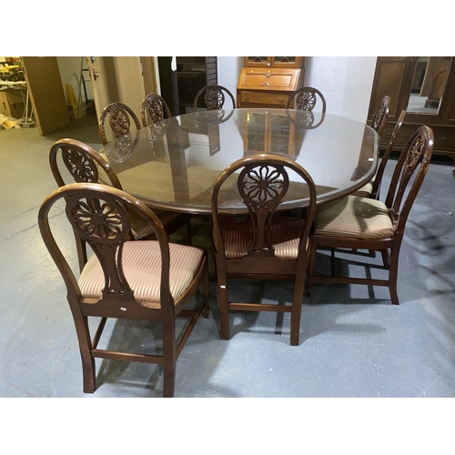 111 - A oval mahogany glass top board room table and ten chairs