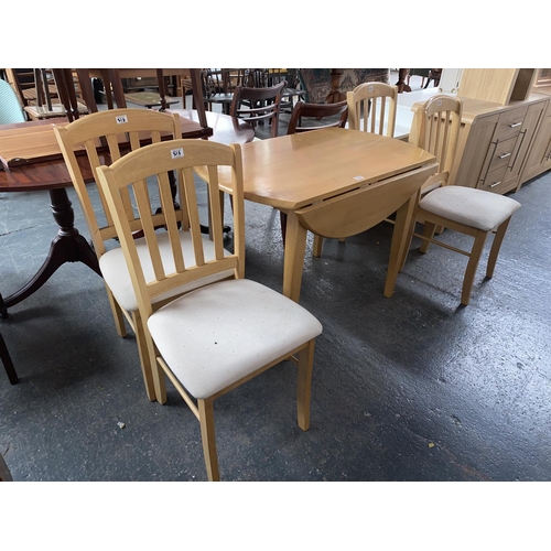 518 - A pine drop leaf dining table and four chairs