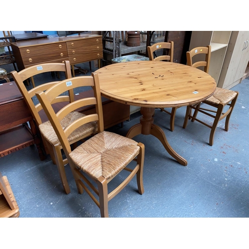 556 - Pine circular dining table and four pine and wicker chairs