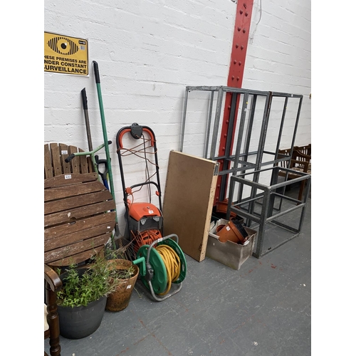 503 - A quantity of garden furniture including lawn mower, garden table and two chairs, aluminium shelving... 