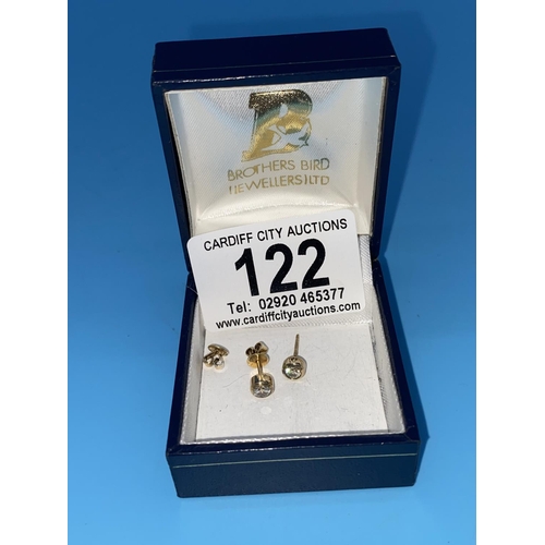 122 - A pair of diamond earrings set in yellow metal -- no hallmarks