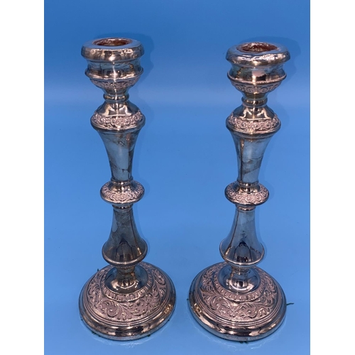 131 - A pair of hallmarked silver candlesticks with weighted bases