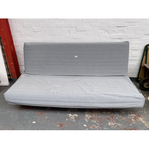 592 - An Ikea click clack sofa bed with removable washable covers