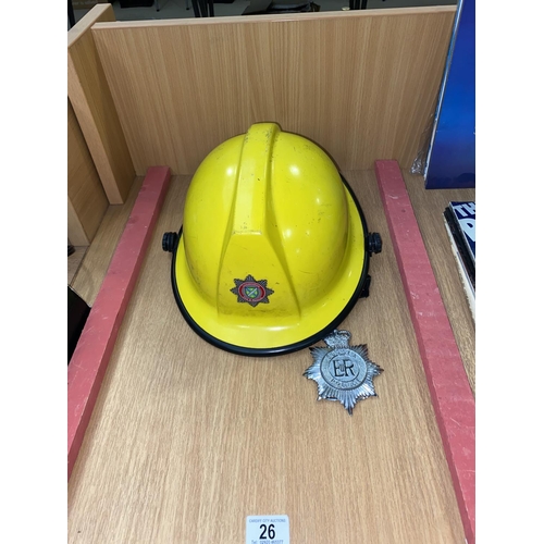 26 - A Lincolnshire fire and rescue helmet and a police badge
