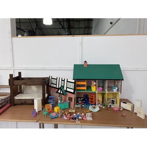 62 - A dolls house with dolls house furniture and a dolls wooden bunk bed