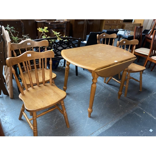 536 - A pine drop leaf dining table and four chairs