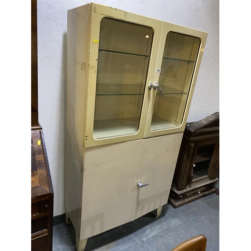 100 - A vintage four door metal hospital cabinet
