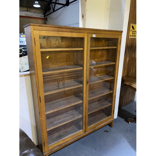 104 - An oak glass fronted bookcase