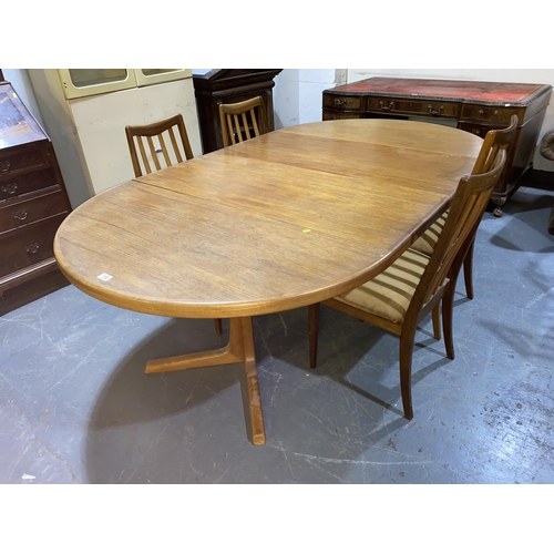 110 - A mid century Danish teak circular extending dining table designed by Oluf T.H Larson and four G Pla... 