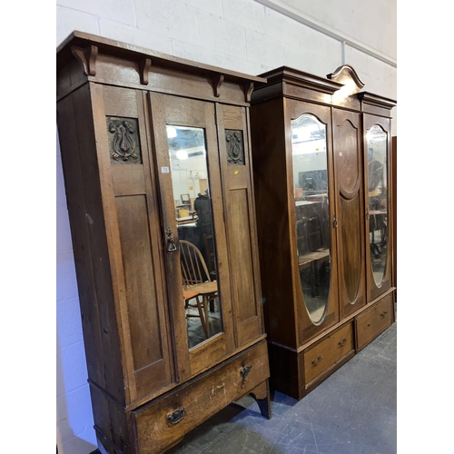 112 - An oak arts and crafts single door wardrobe with mirror and two beaten copper panels