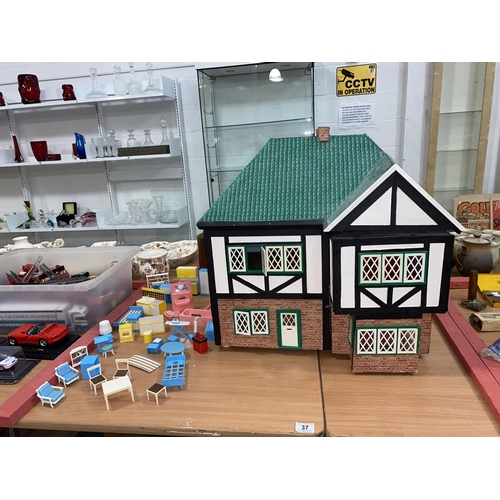 37 - A large dolls house with furniture