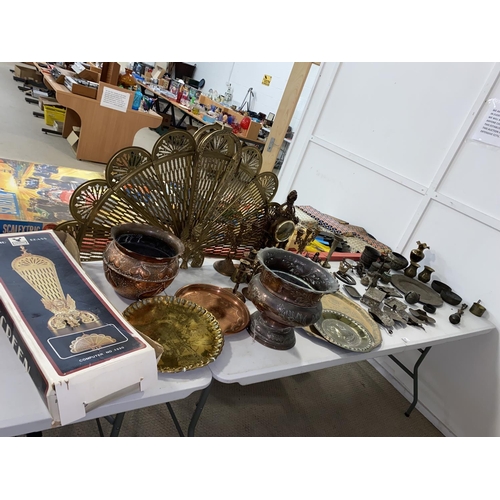 67 - Mixed metalware including chargers, candlesticks, brass nutcracker, boxed brass peacock firescreen