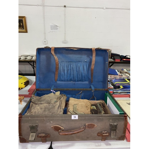 94 - A military suitcase with 2nd world war helmet, belts, badges etc.