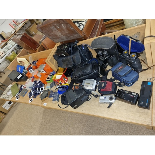 30 - Binoculars, Sony camera, movie cameras together with a large collection of slides etc.