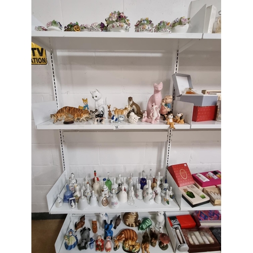 52 - Animal collectable figures together with collectable figurines china bells etc - 4 shelves