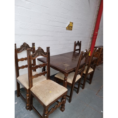 306 - An oak extending dining table and five chairs