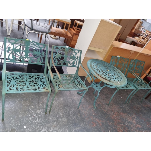 314 - A cast iron garden table and four chairs