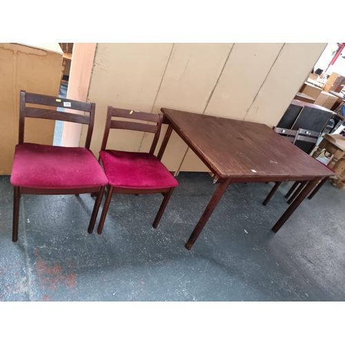 315 - A teak extending dining table and four chairs