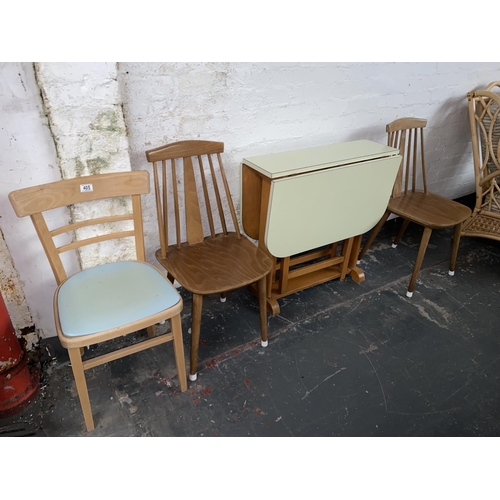 405 - A Formica drop leaf kitchen table and three chairs