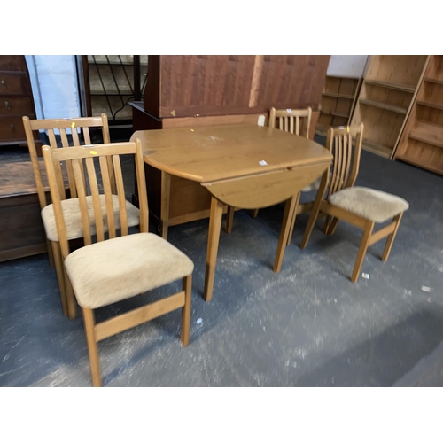 530 - A drop leaf dining table with four chairs