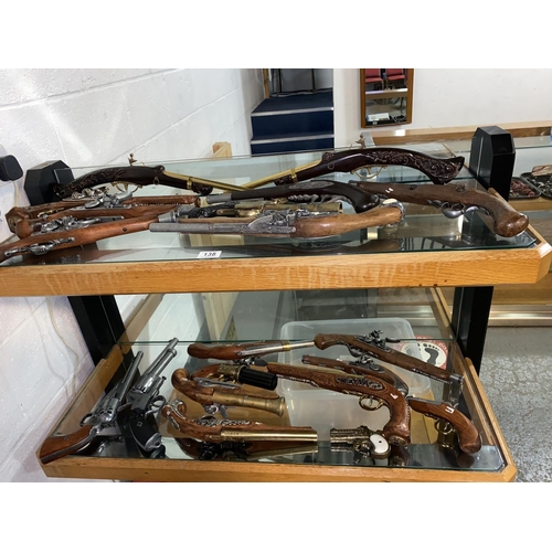 138 - A collection of replica antique guns - two shelves