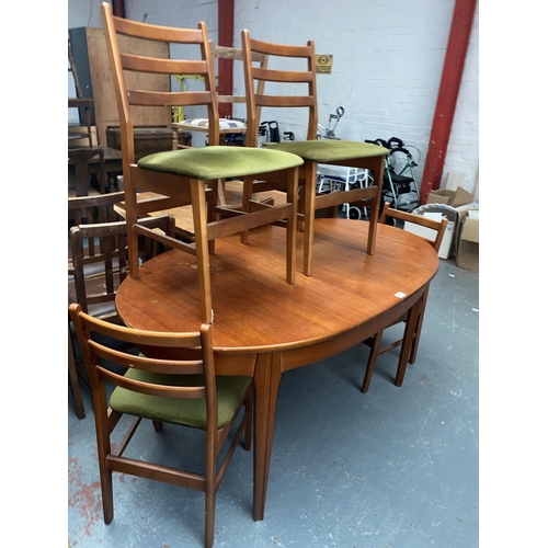 485 - A teak oval dining table and four dining chairs