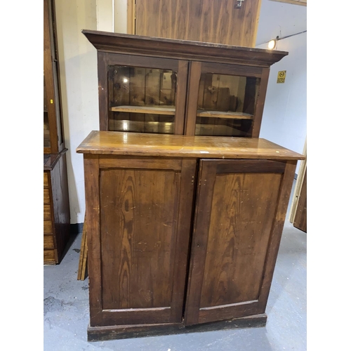 126 - A large pine school cupboard with glazed upper section