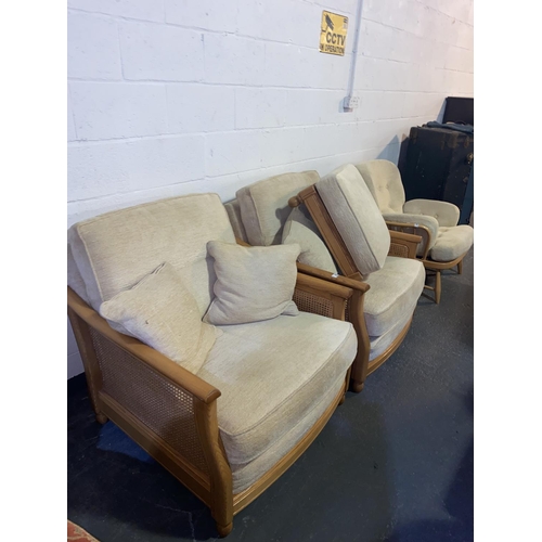 85 - A Ercol Bergere armchair/ lounge chairs and a footstool- cream upholstery
