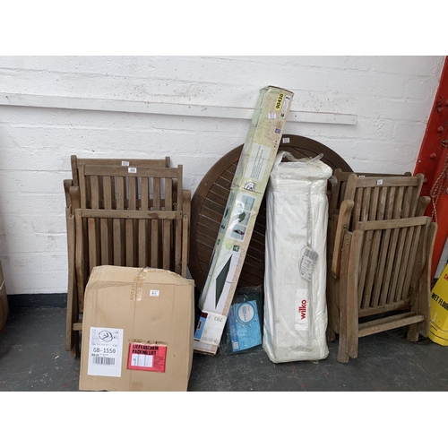 303 - A wooden garden table and four chairs, a parasol etc.