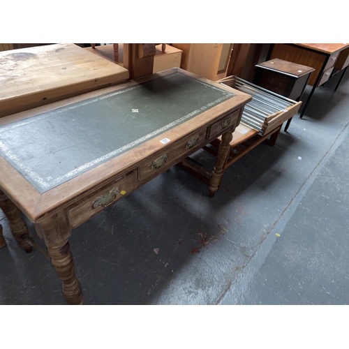 337 - A leather top three drawer desk, pine fire surround, tile top coffee table, bedside cabinet etc.