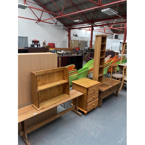 343 - A pine bench, pine coffee table, bedside cabinet, wall rack and CD rack