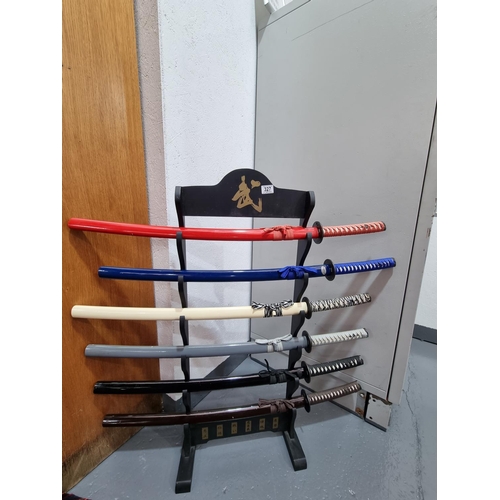 327 - Six collectible Samurai swords on wooden stand - Nemesis