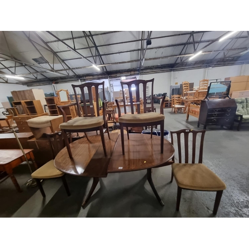 722 - An oak extending dining table and 4 chairs including 2 carvers