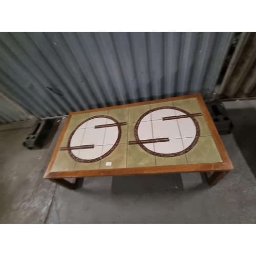 764 - A mid-century tiled top teak coffee table - with signature on one of the tiles