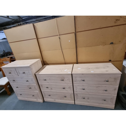 775 - An oak effect 3 over 2 chest of drawers and 2 x 3 drawer chest of drawers