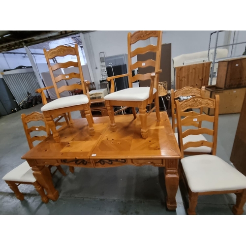 776 - A pine extending dining table and 6 chairs to include 2 carvers