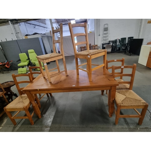 777 - A pine dining table and 6 chairs with wicker seats