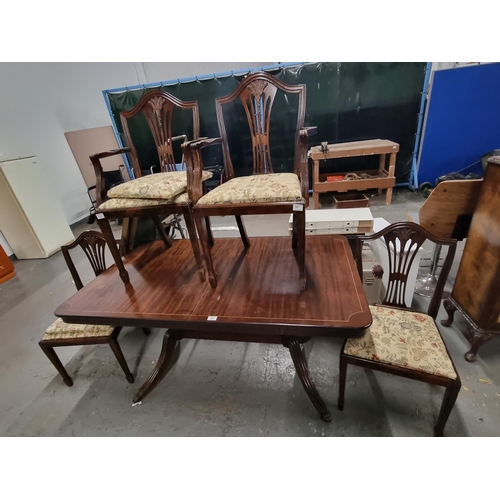 781 - A mahogany dining table and 6 chairs to include 2 carvers