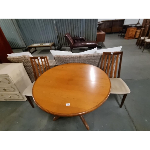 792 - A mid-century teak circular dining table and two G Plan dining chairs