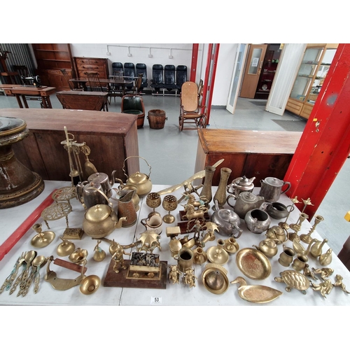53 - A collection of metalware including brass ornaments, silver plated kettles, brass fire companion, et... 