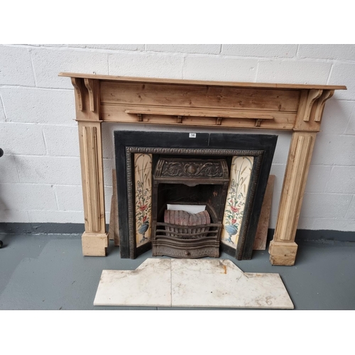 146 - A cast iron fireplace with a pine surround