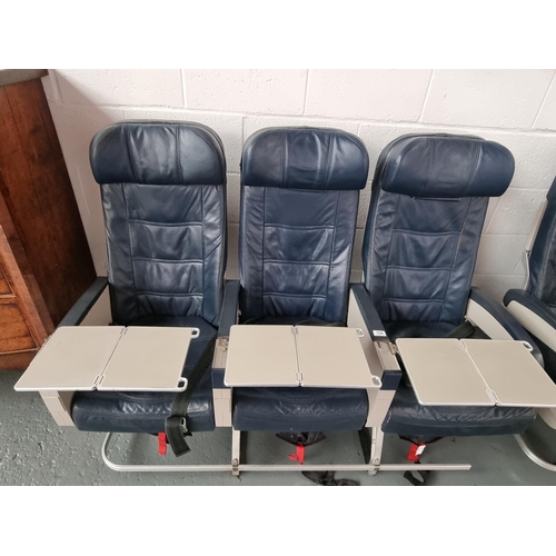 154 - A set of three leatherette aircraft passenger seats with pull out trays