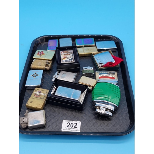 202 - Vintage cigarette lighters to include Harley Davidson and other Zippos, Penguin, Rolstar, etc