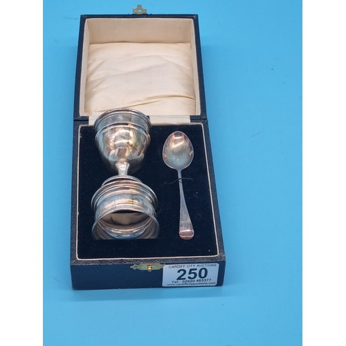 250 - A hallmarked boxed silver christening set comprising of an egg cup, spoon and serviette ring (engrav... 