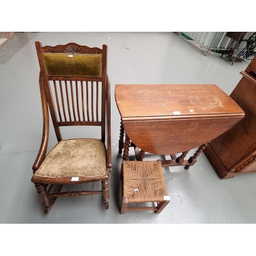 115 - An oak drop leaf table on barley twist supports, a stool and a rocking chair