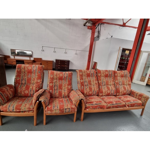 121 - An Ercol three seater sofa with two matching armchairs