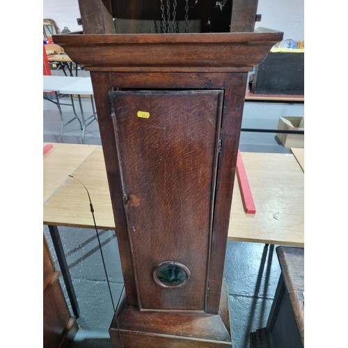 70 - An oak cased Stringer of Stockport Grandfather clock with pendulum and weight