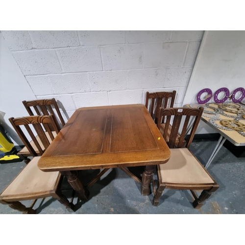 754 - An oak dining table and 4 chairs