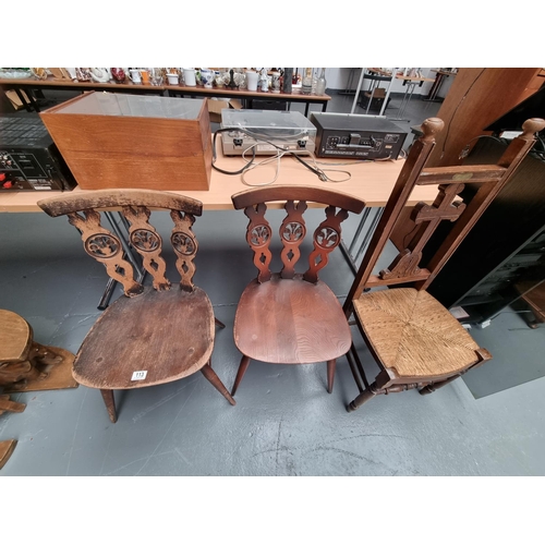 113 - Two Ercol Fleur de Lis dining chairs and a rush seated ecclesiastical chair