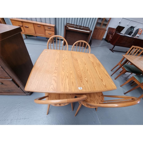 120 - An Ercol extending dining table and four chairs